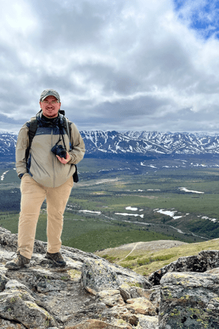 Recent W&J alumnus Jeffrey Seabury, Jr. '22 stands atop a mountain in Alaska during his Magellan Project.